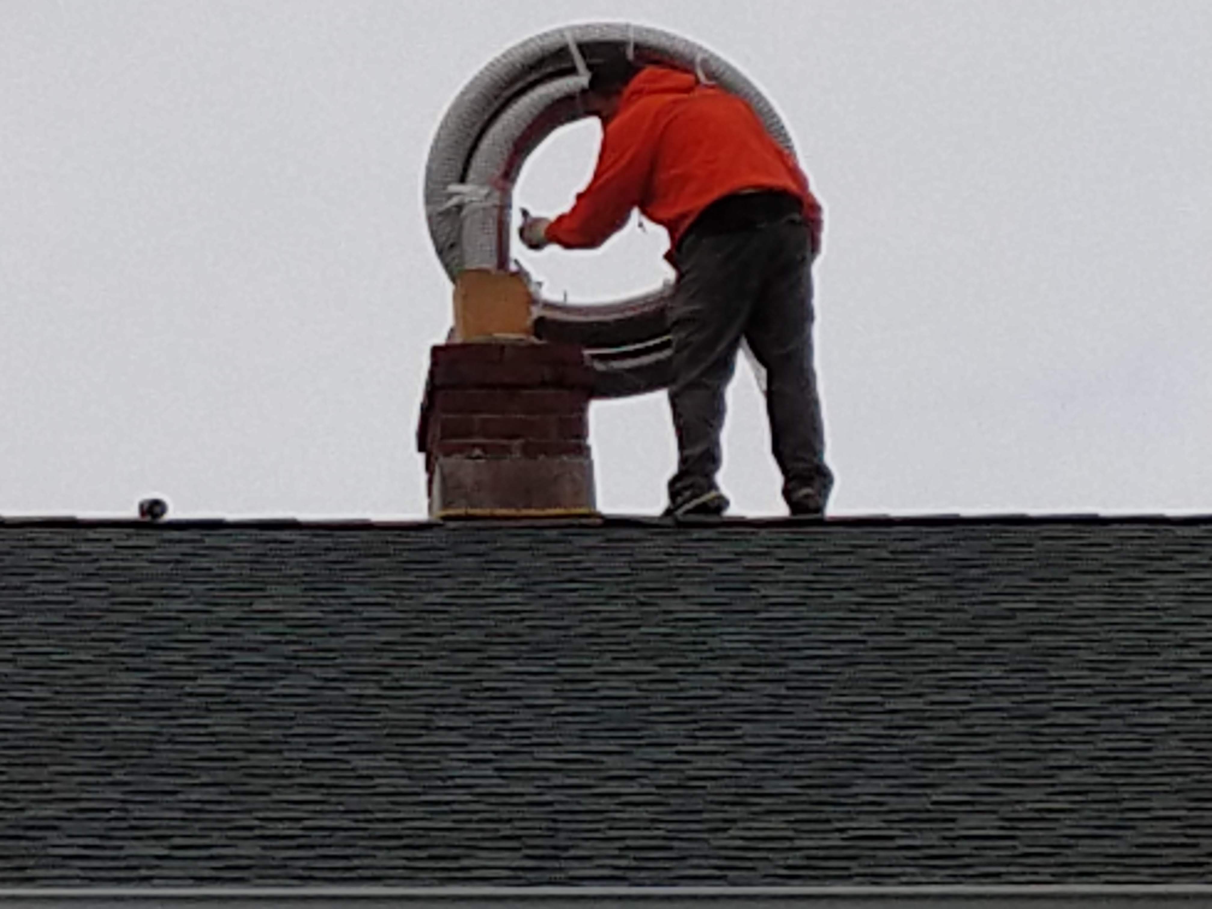 Flexible stainless chimney liner being installed in Central Islip, New York